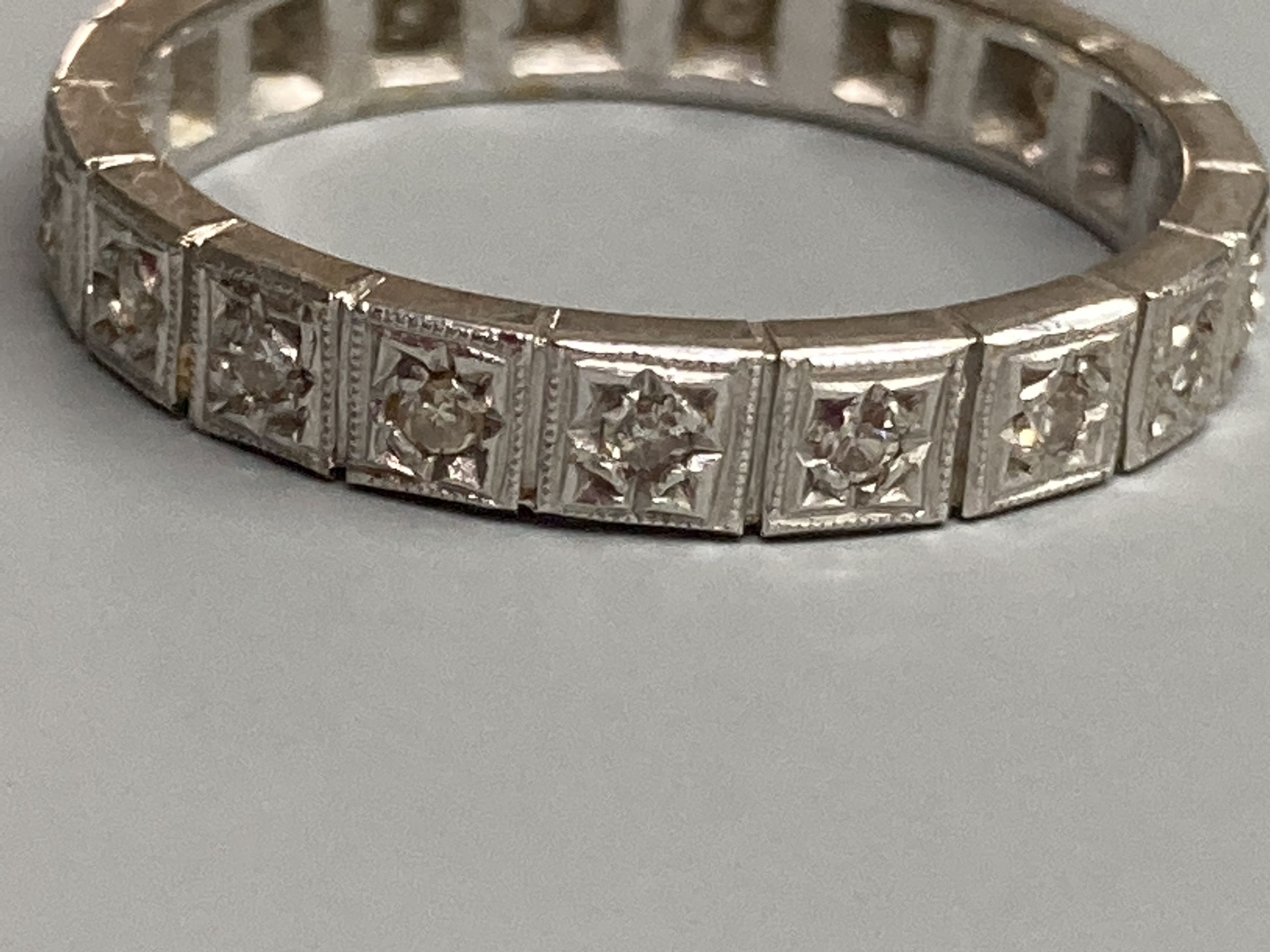 A modern white metal and diamond chip set full eternity ring, total carat weight approx. 0.35ct, size R, gross 4.2 grams.